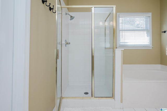 bathroom with separate shower and tub