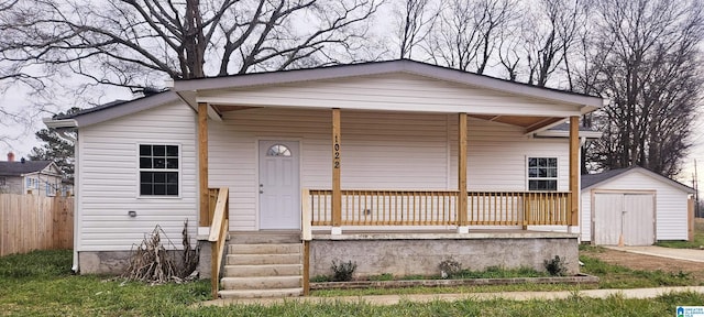 view of front of property featuring a porch and a storage unit