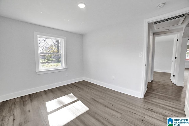 spare room with wood-type flooring