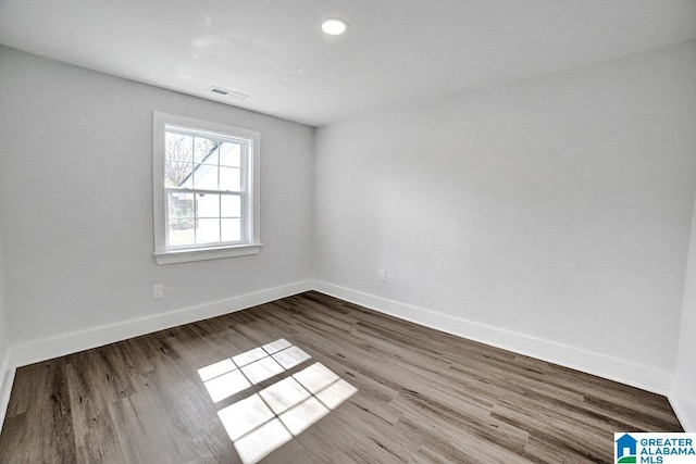 spare room featuring hardwood / wood-style flooring