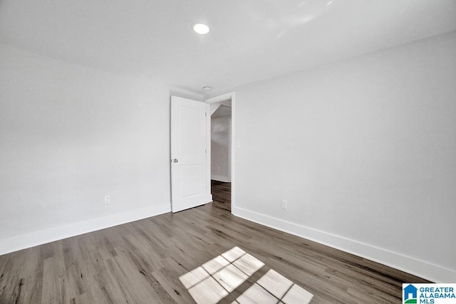 spare room featuring wood-type flooring