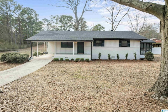 ranch-style house featuring a carport and a sunroom