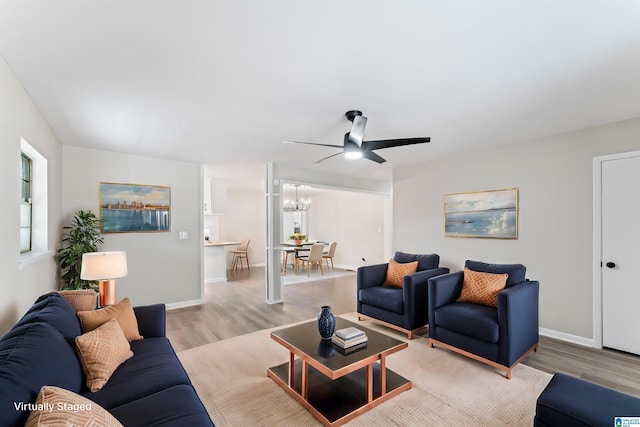 living room with a chandelier and light wood-type flooring