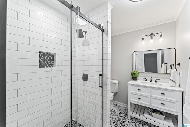 bathroom featuring vanity, an enclosed shower, toilet, crown molding, and tile patterned floors