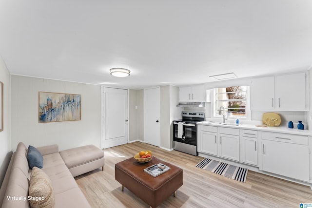 living room featuring sink and light wood-type flooring