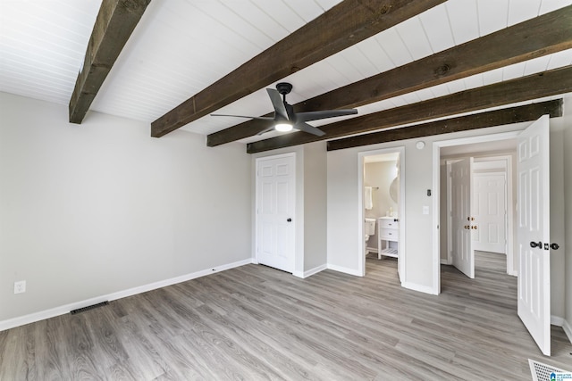 unfurnished bedroom with ceiling fan, beamed ceiling, and light wood-type flooring