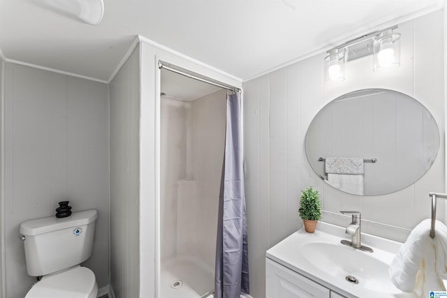 bathroom with vanity, ornamental molding, toilet, and walk in shower