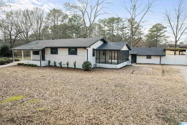 view of front of home featuring a carport and a sunroom