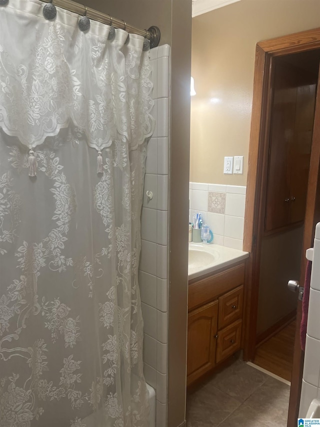 bathroom featuring shower / tub combo with curtain, tile patterned floors, and vanity