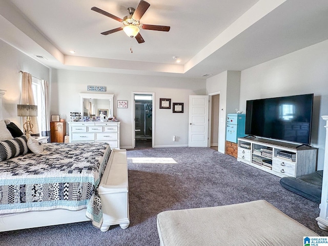 carpeted bedroom featuring a raised ceiling and ceiling fan