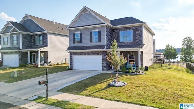 craftsman house with a garage and a front lawn