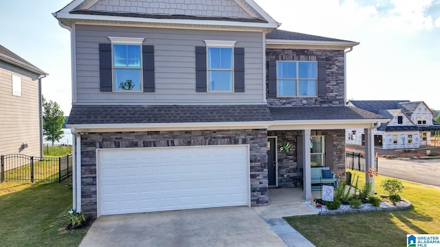 craftsman-style home featuring a garage and a front lawn