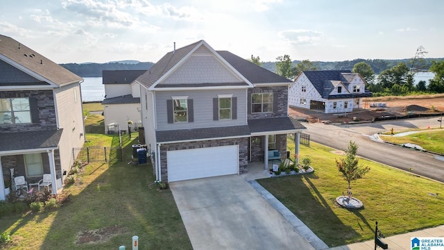 view of front of house featuring a garage and a front lawn