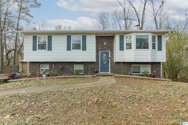 split foyer home with a front lawn