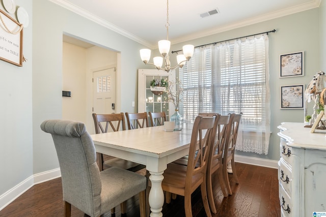 dining area featuring dark hardwood / wood-style flooring, a notable chandelier, and ornamental molding