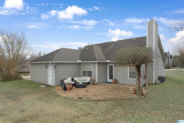 back of house featuring a yard and an outdoor living space