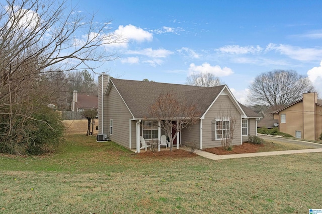 view of front facade with central AC unit and a front lawn