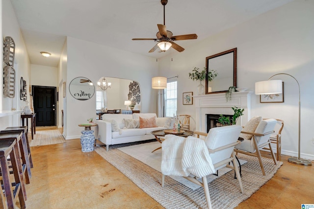 living room featuring ceiling fan with notable chandelier