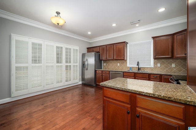 kitchen with dark hardwood / wood-style floors, sink, light stone counters, stainless steel appliances, and crown molding