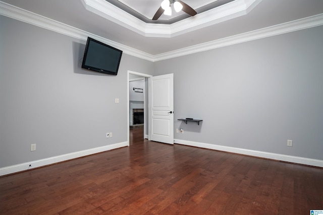 spare room with hardwood / wood-style floors, crown molding, a raised ceiling, and ceiling fan