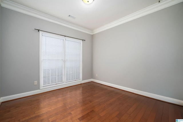 spare room featuring ornamental molding and hardwood / wood-style floors