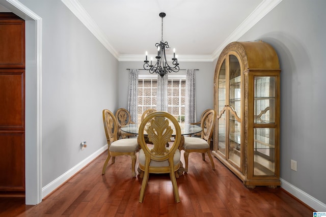 dining room with an inviting chandelier, dark hardwood / wood-style flooring, and crown molding