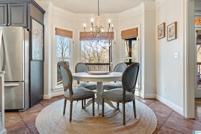 dining area featuring ornamental molding, plenty of natural light, and a chandelier