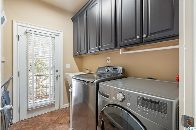 laundry room featuring cabinets, independent washer and dryer, sink, and light tile patterned floors