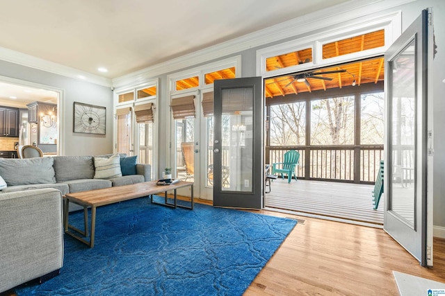 doorway to outside featuring hardwood / wood-style floors and crown molding