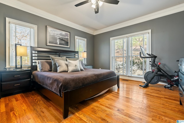 bedroom featuring crown molding, ceiling fan, and light hardwood / wood-style flooring