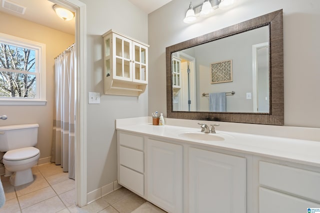 bathroom featuring vanity, tile patterned floors, and toilet