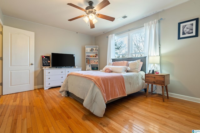 bedroom with light hardwood / wood-style floors and ceiling fan