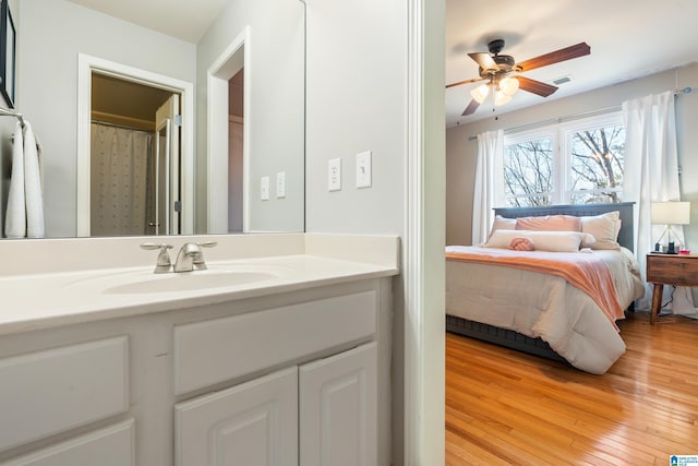 bedroom with sink and light hardwood / wood-style flooring