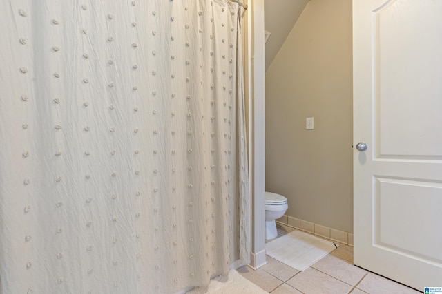 bathroom with tile patterned flooring and toilet