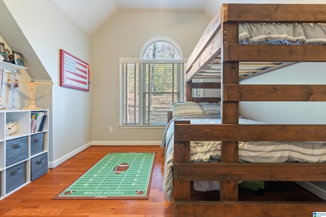 bedroom with lofted ceiling and hardwood / wood-style flooring