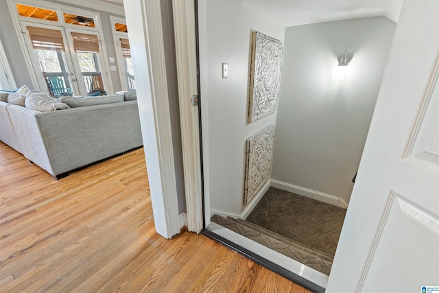 bathroom featuring hardwood / wood-style flooring, lofted ceiling, and french doors