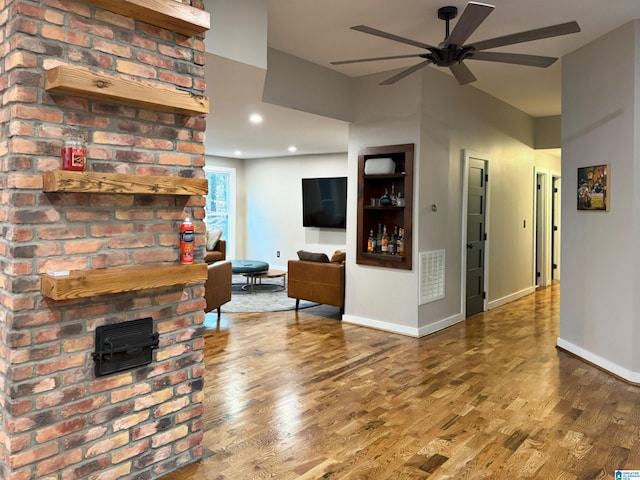 unfurnished living room with hardwood / wood-style floors and ceiling fan