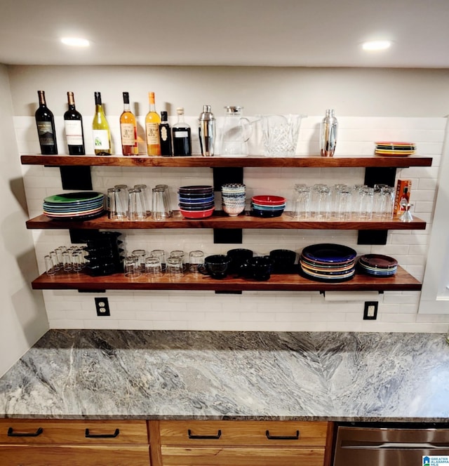 bar with dishwasher and stone countertops