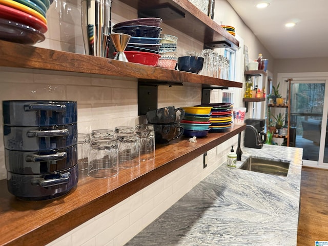 kitchen with hardwood / wood-style flooring, sink, and decorative backsplash