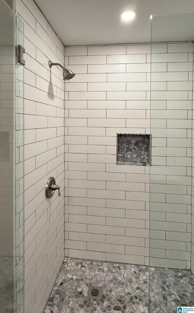 bathroom with tiled shower