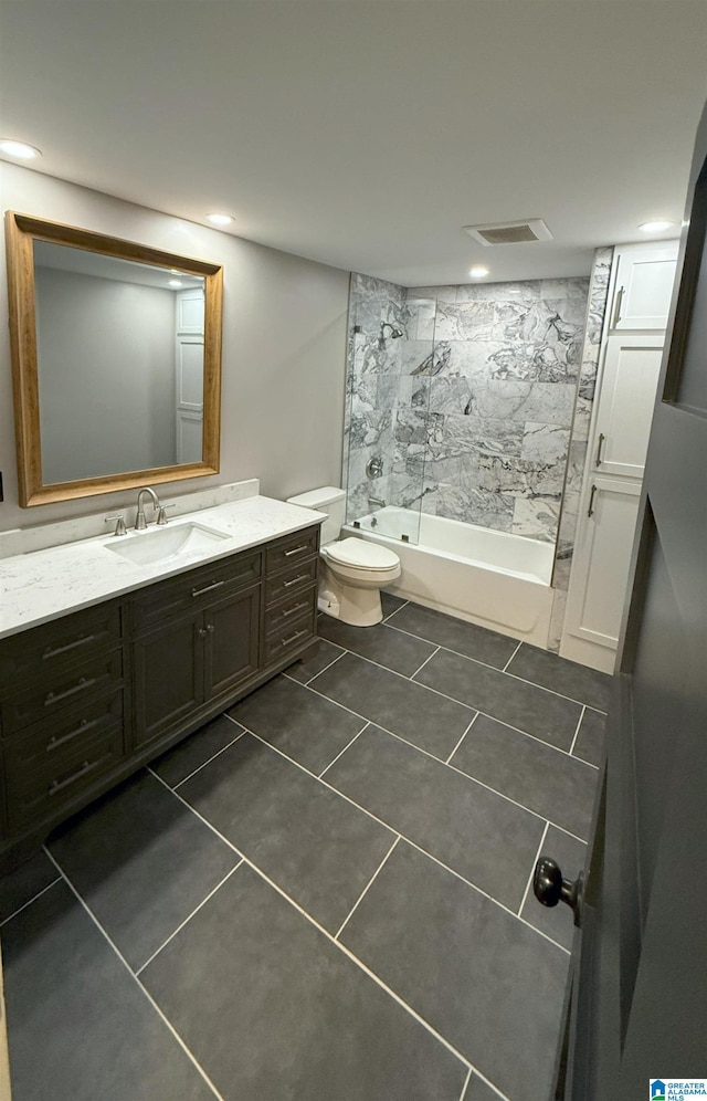 full bathroom with vanity, toilet, tiled shower / bath combo, and tile patterned flooring