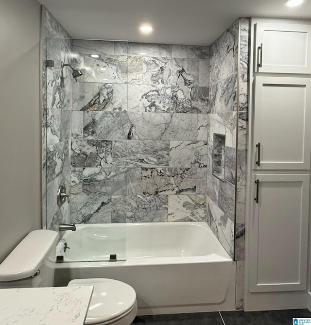 bathroom featuring toilet and tiled shower / bath combo