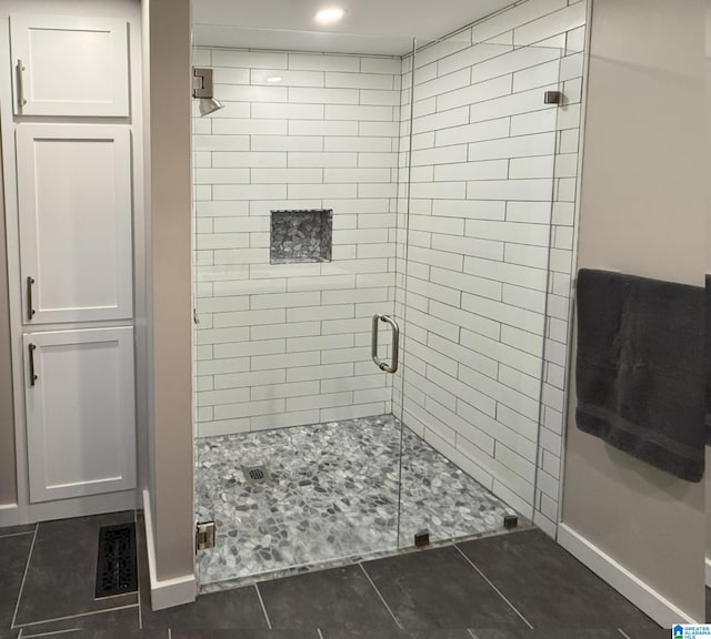 bathroom featuring tile patterned flooring and a shower with door