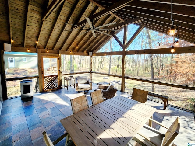 unfurnished sunroom with wood ceiling, ceiling fan, and vaulted ceiling with beams