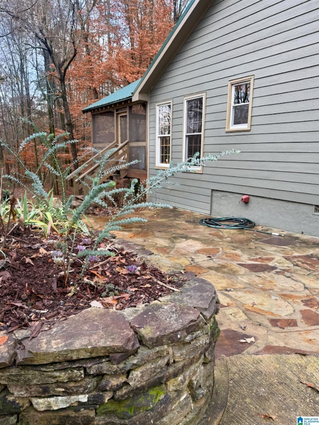 exterior space with a sunroom and a patio area