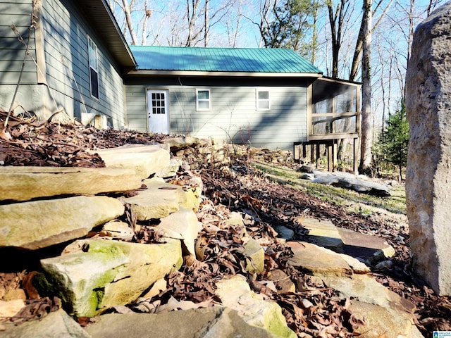 view of property exterior featuring a sunroom