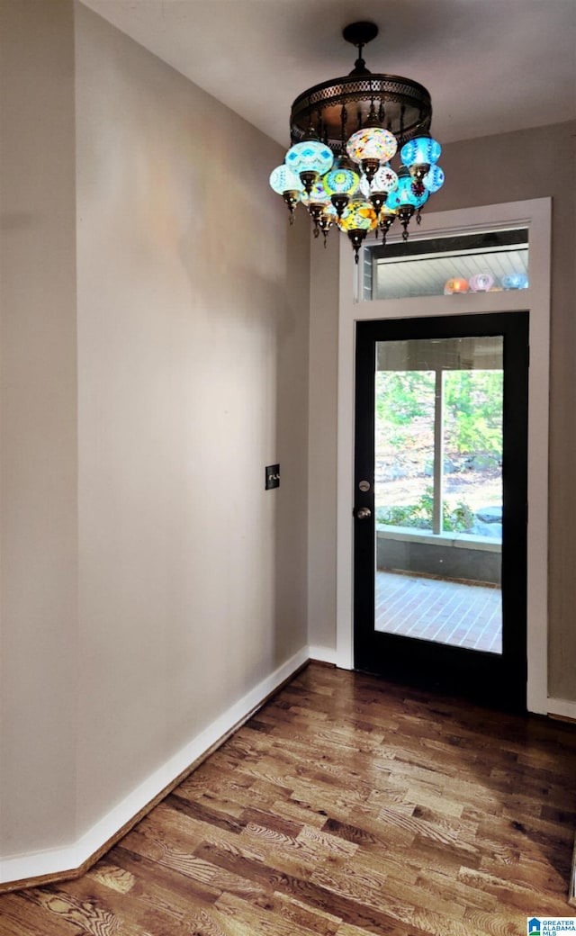 interior space with a chandelier and hardwood / wood-style floors