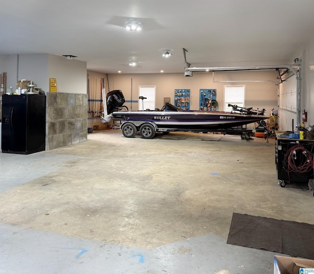 garage with black fridge with ice dispenser