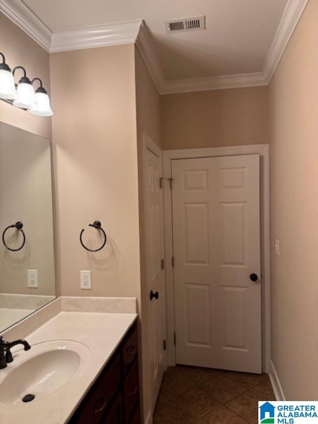 bathroom featuring vanity, tile patterned floors, and crown molding