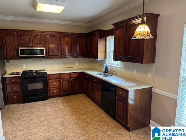 kitchen featuring sink, backsplash, ornamental molding, black appliances, and decorative light fixtures